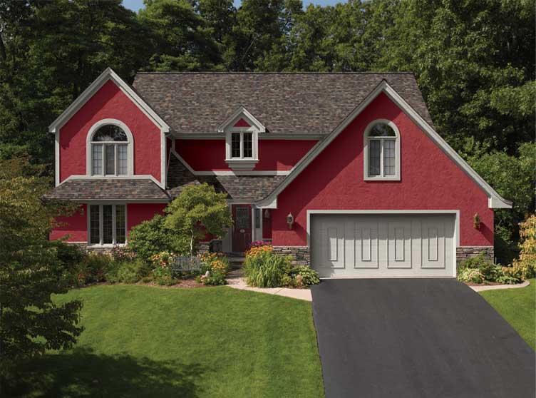 A red house featuring a driveway and a garage, set against a clear blue sky.