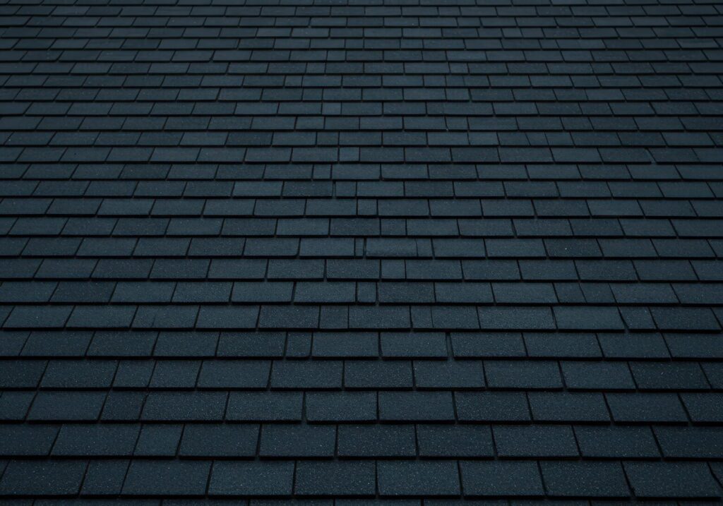 Rows of overlapping dark gray architectural shingles