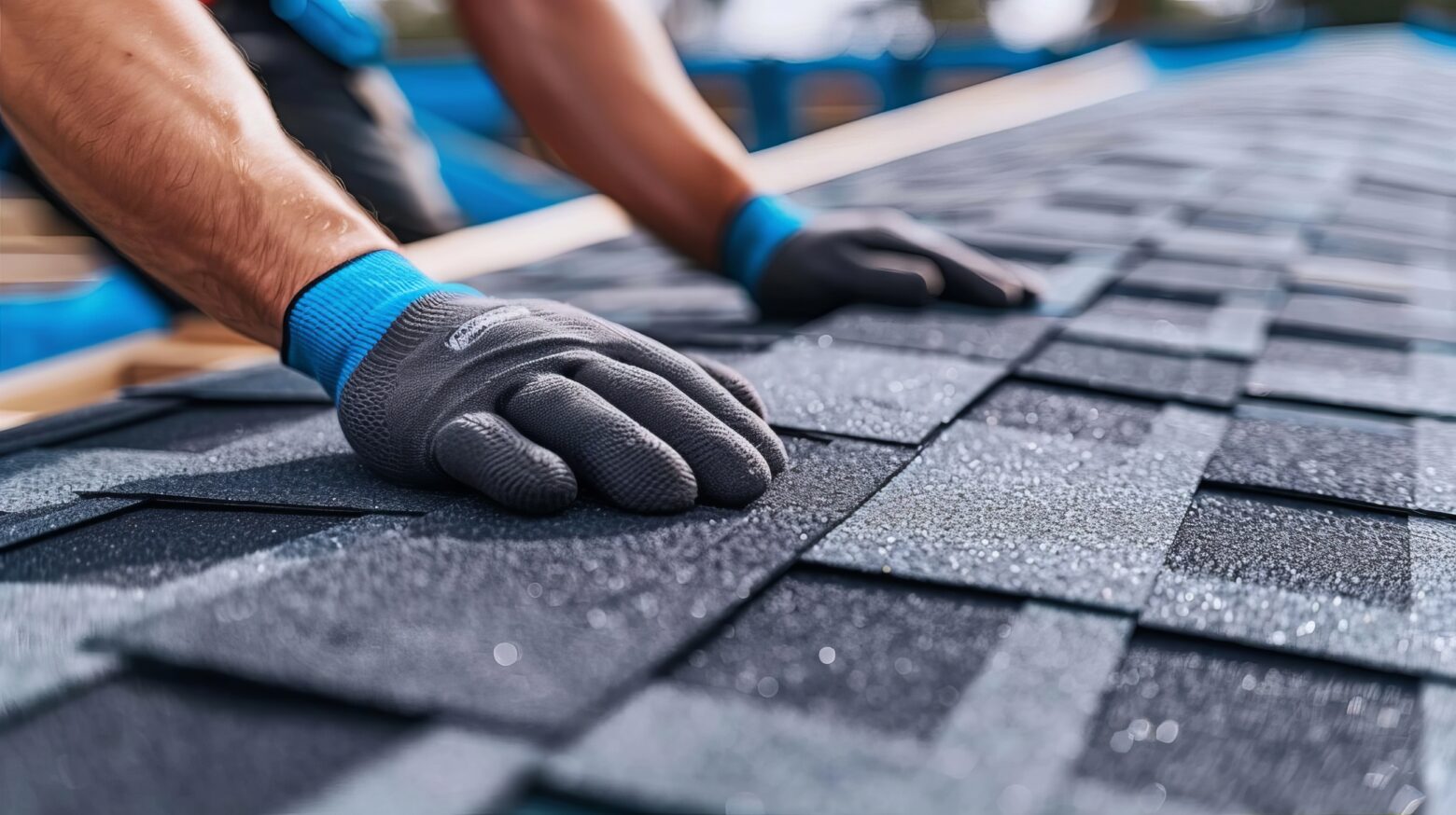 Skilled roofer fitting new grey asphalt shingles for enhanced protection on home roof